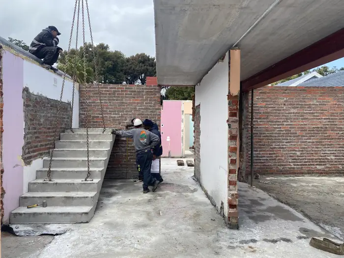 A cast concrete staircase lowered into place at House Braeview, against one of the few walls that stayed