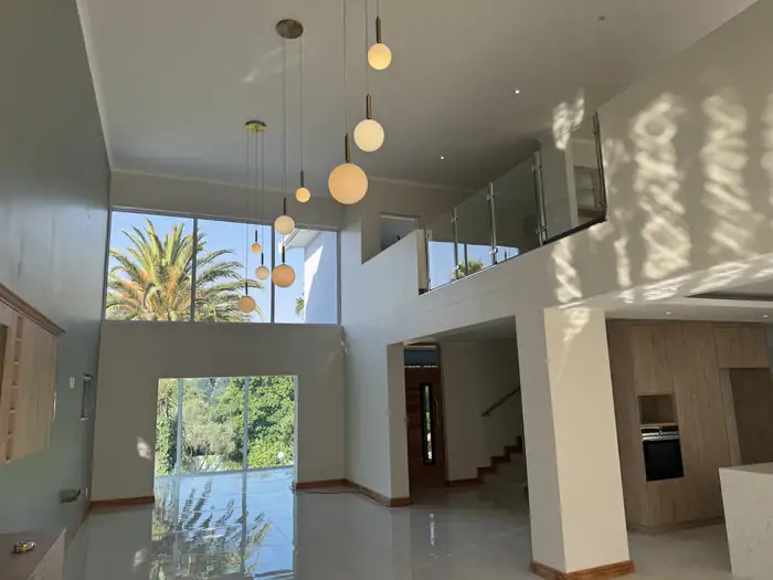 Pendant lights hanging through the double volume above the living area