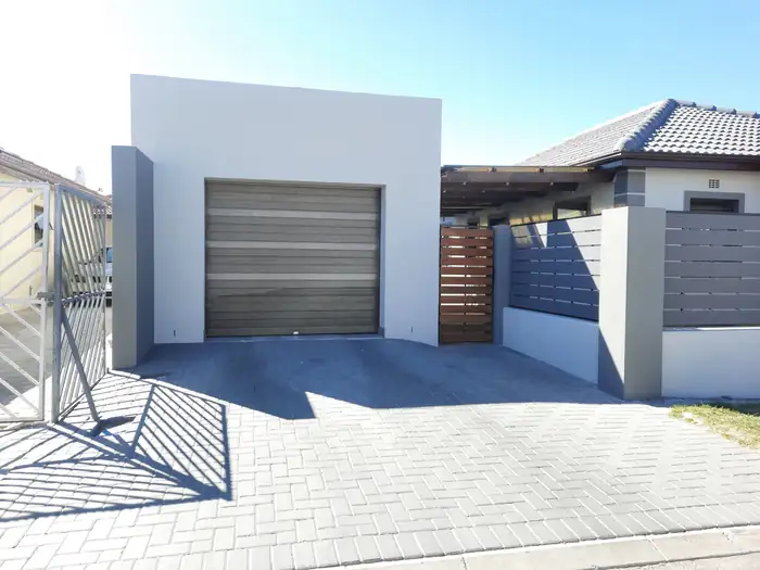 The garage and paved driveway from the street side