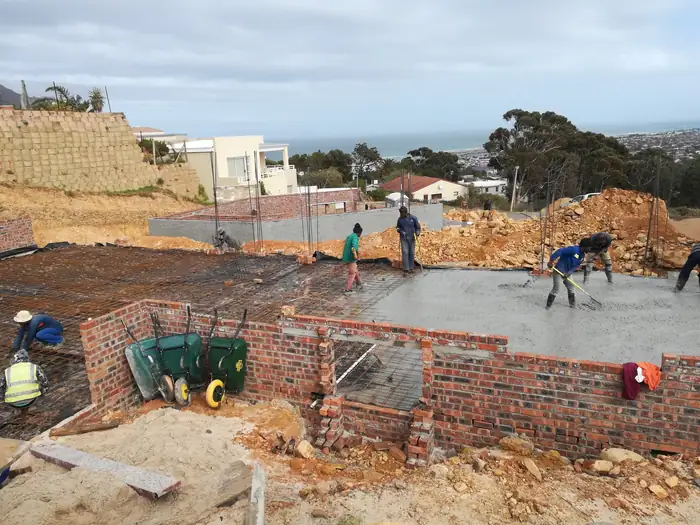 The team working a concrete slab at House Chapman