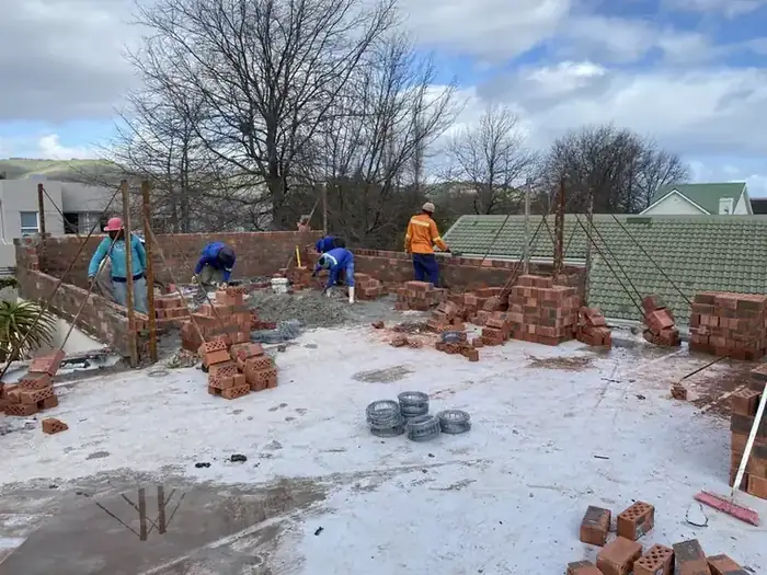 Our team laying the first courses of the new storey