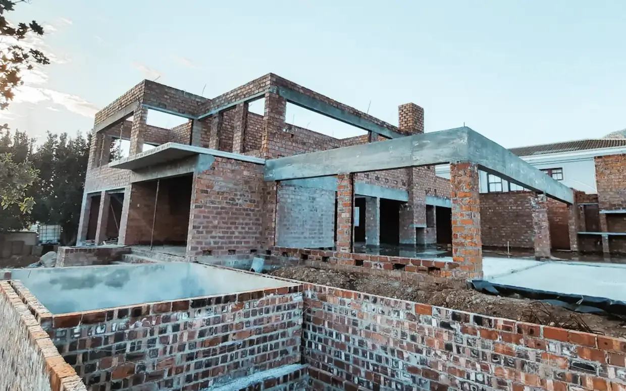 Brickwork going up at House Hillcrest with the pool shell cast in the foreground