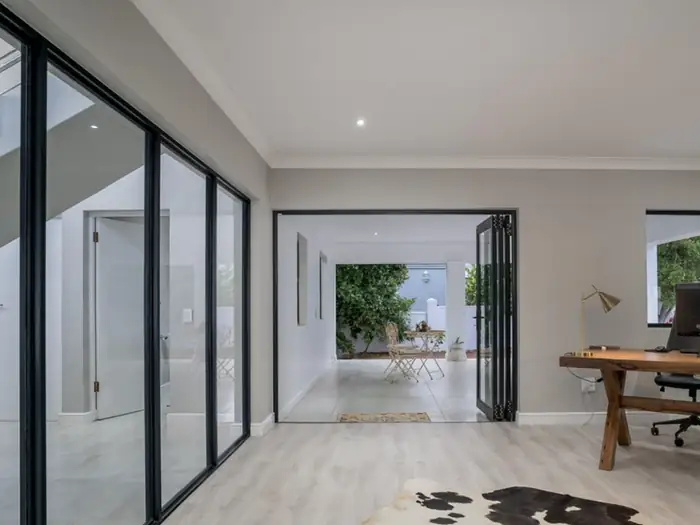 The study at House Hillcrest opening onto the garden through stacker doors