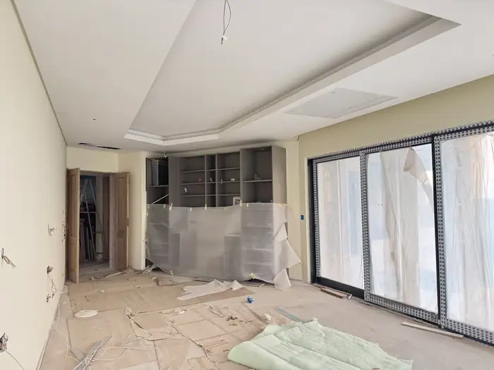 Ceiling bulkheads and a built-in joinery niche taking shape inside the house