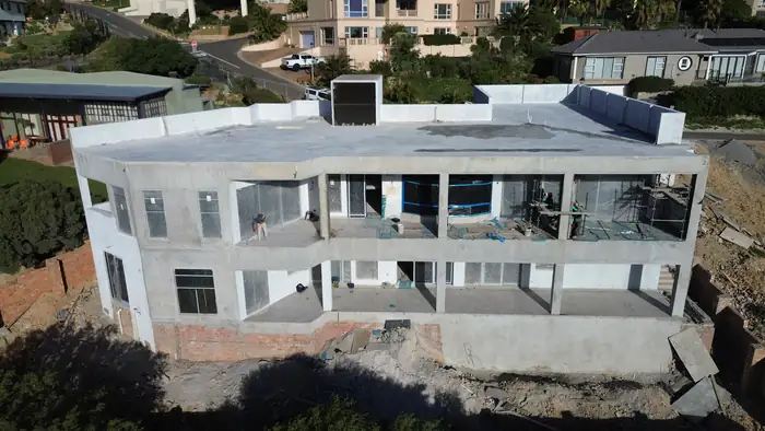 House Makhene as a grey concrete and brick shell, before plaster and glazing
