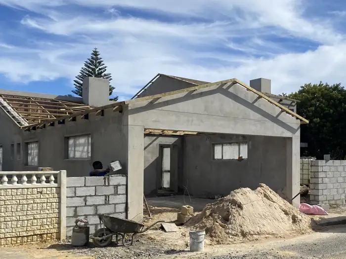 Roof timbers going on over the plastered gable of the street front section