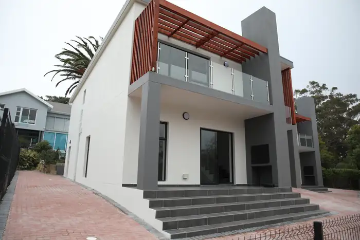 The finished front elevation with the timber pergola over the balcony