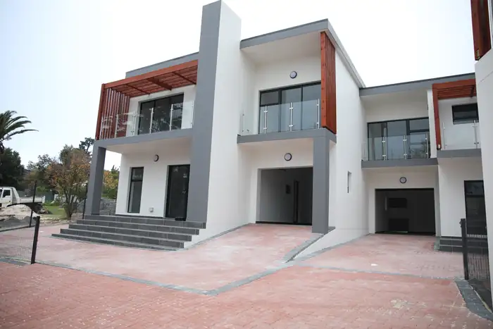 The finished frontage of two of the three houses from the shared paving