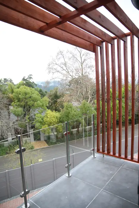 A vertical timber screen on the corner of one of the houses