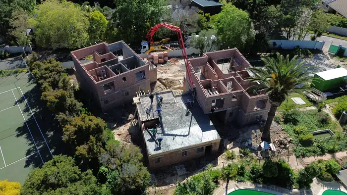 First floor walls up across the site in October 2025