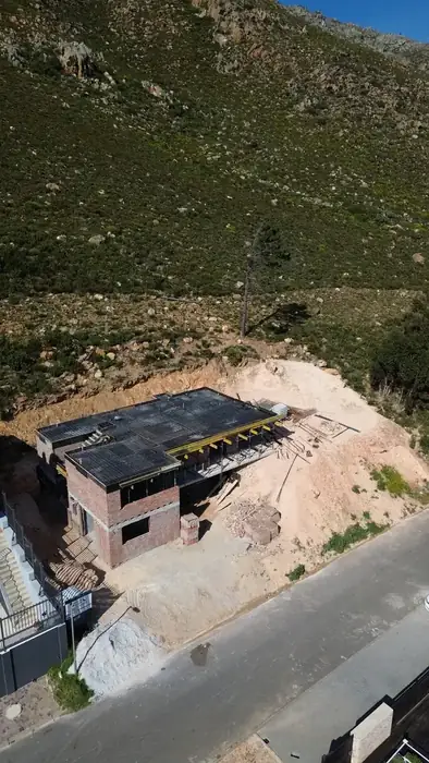 The in-situ slab cast with the mountain rising straight behind the house